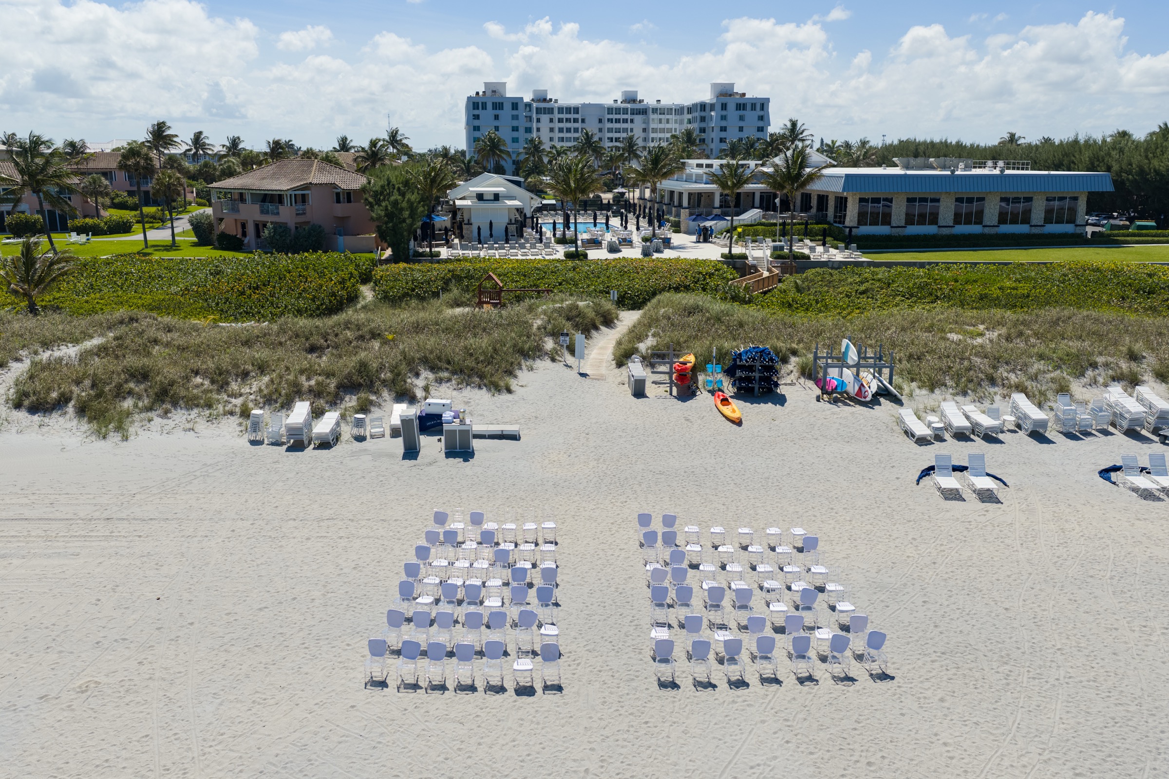 Aerial view of beach wedding ceremony setup at the Delray Beach Club, chairs arranged on white sand with the Atlantic Ocean behind