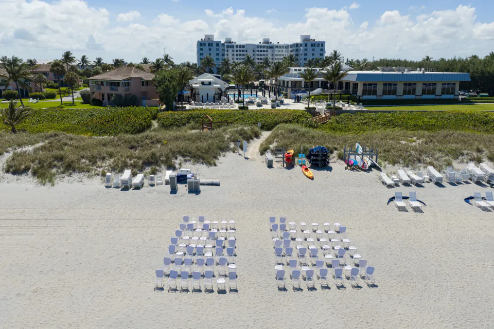John and Reed standing in front of the Delray Beach Club entrance sign on their wedding day