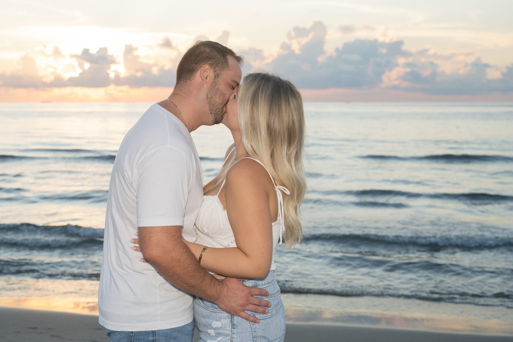 Couple photographed in warm golden hour light during their wedding day portraits